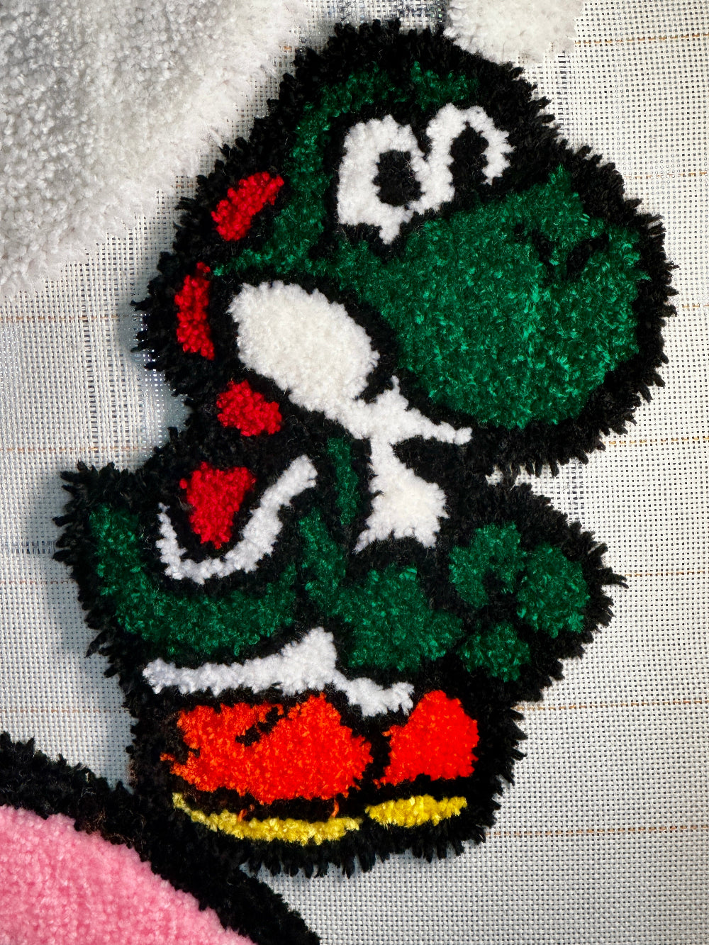 Embroidered patch of a cartoon character with green hair and red shoes on a white background